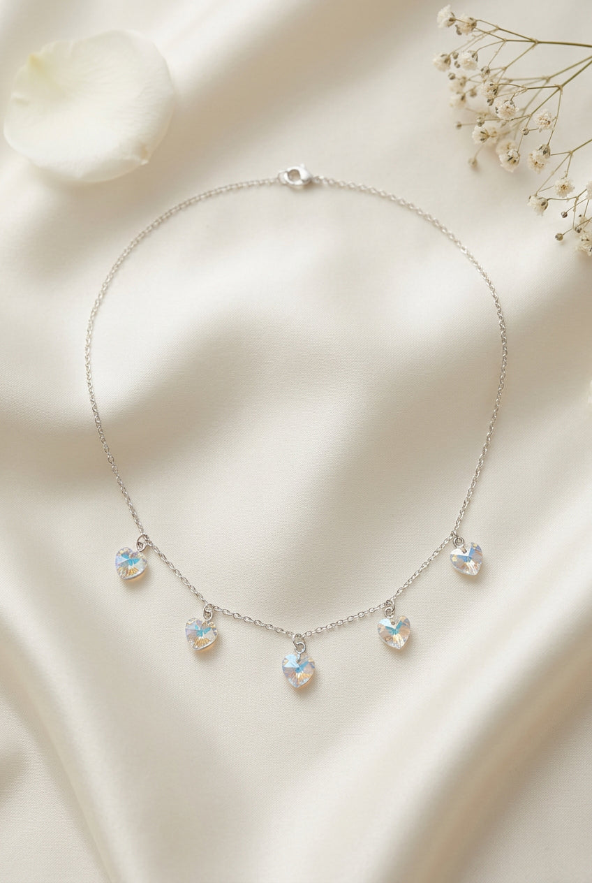 5 crystal hearts with prism like color to them on a necklace for wedding jewelry , brides or bridesmaids.