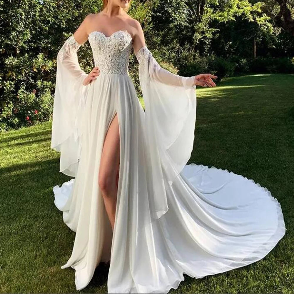 Elegant woman wearing a trumpet sleeves detachable chiffon dress in a garden, showcasing lace details and flowing train.