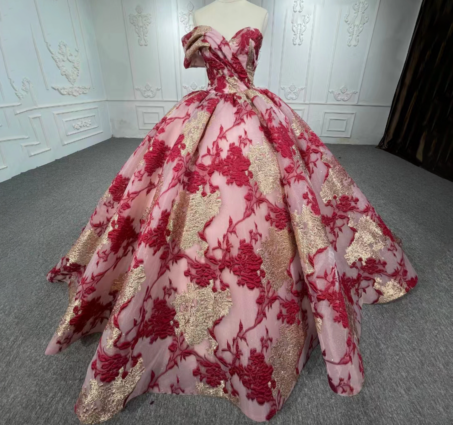 Quinceanera Dress Multi Color Gold Burgundy Ball Gown, Showcasing exquisite details, this dramatic ballgown features an off-shoulder one-cuff pleated sleeve, a draped bodice