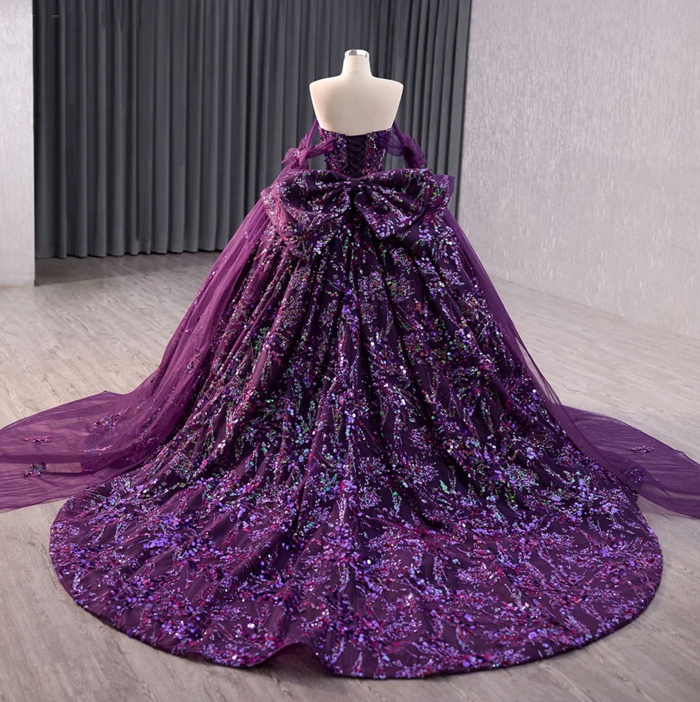 Deep purple floral ball gown with sequins and sweeping train for Quinceañera, featuring a sweetheart neckline and lace-up back.