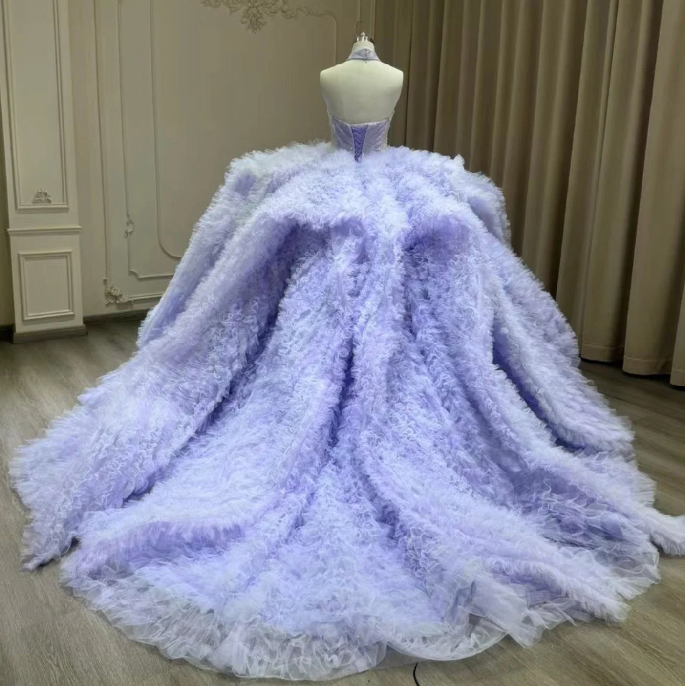 Elegant purple Quinceanera 3D floral ball gown dress featuring a full ruffled skirt and lace-up back detail.