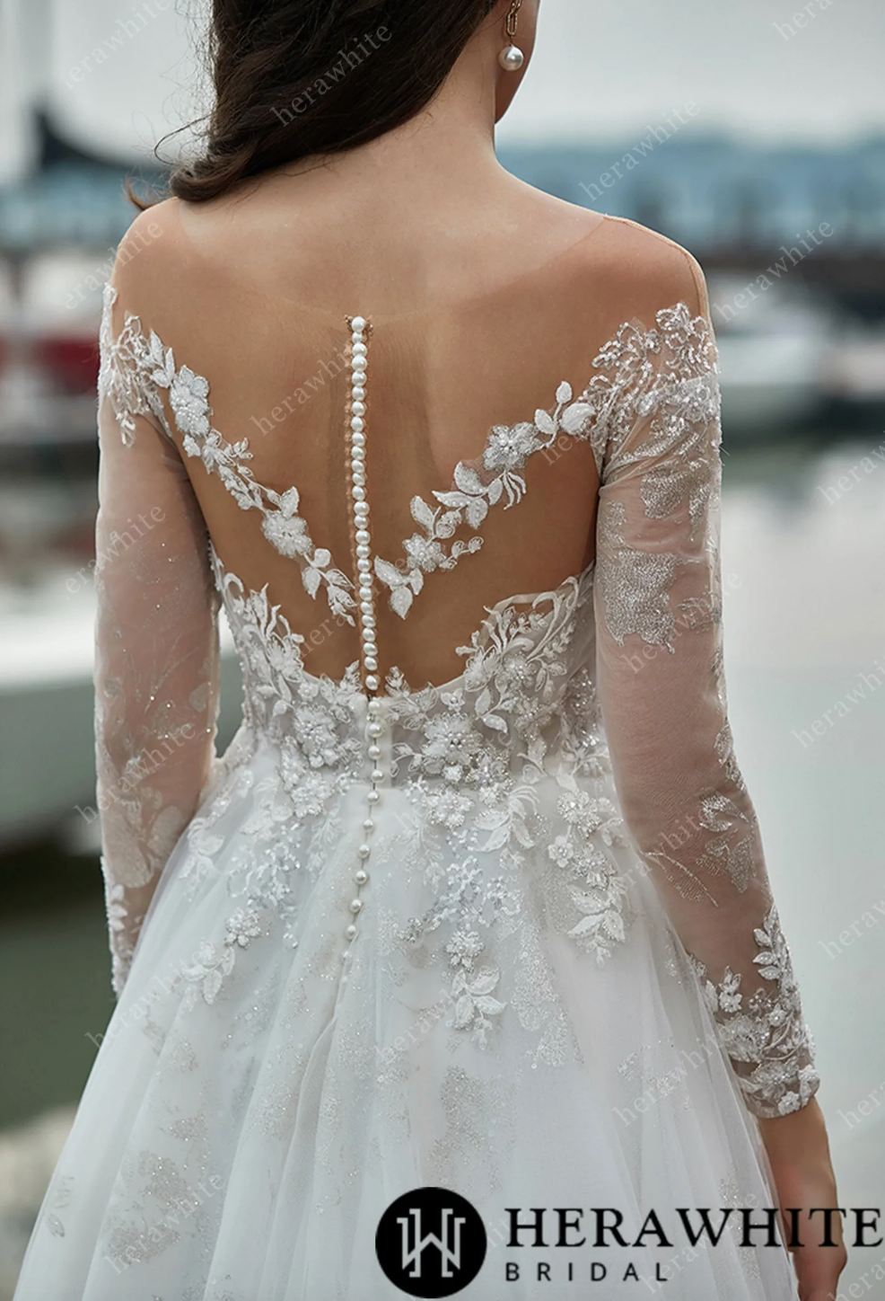 Back view of shimmer long sleeves wedding dress with illusion back and pearl button details, showcasing elegant floral lace.