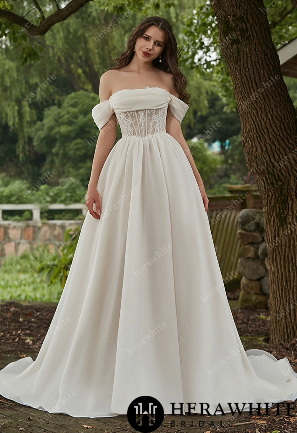 Elegant off-the-shoulder A-line organza wedding dress with lace bodice and flowing skirt, perfect for brides.