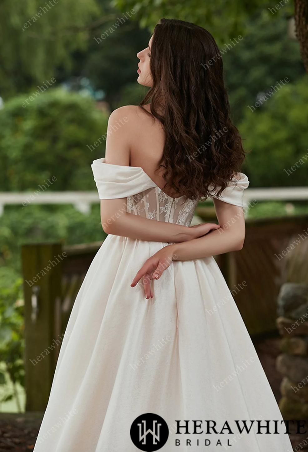 Elegant off-the-shoulder A-line wedding dress showcases luxurious organza and delicate lace details from the back.