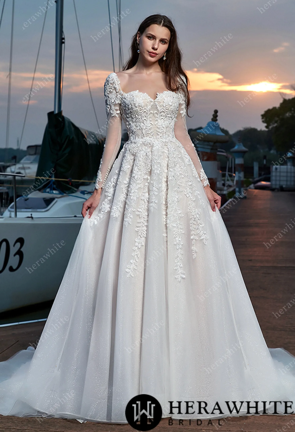 Elegant vine long sleeve wedding dress with sweetheart neckline and intricate lace appliques.