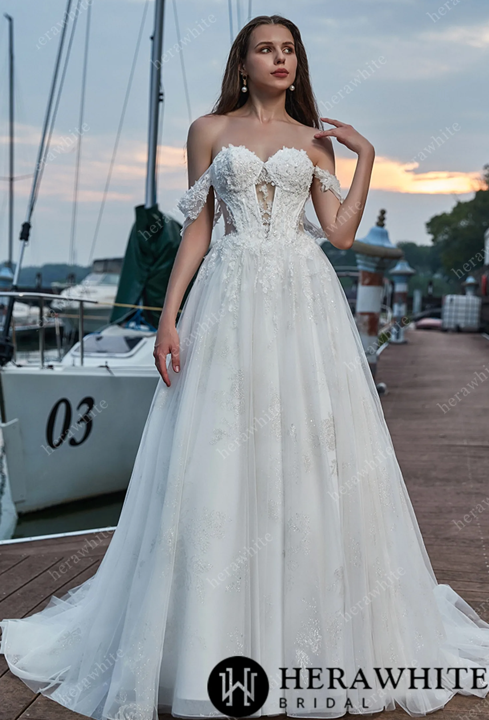 Elegant off-shoulder sweetheart wedding dress with lace bodice and voluminous skirt, perfect for brides.