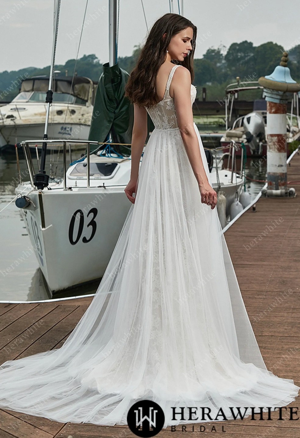Elegant lace wedding dress with detachable overskirt, showcasing a sweetheart neckline and sheer back details.