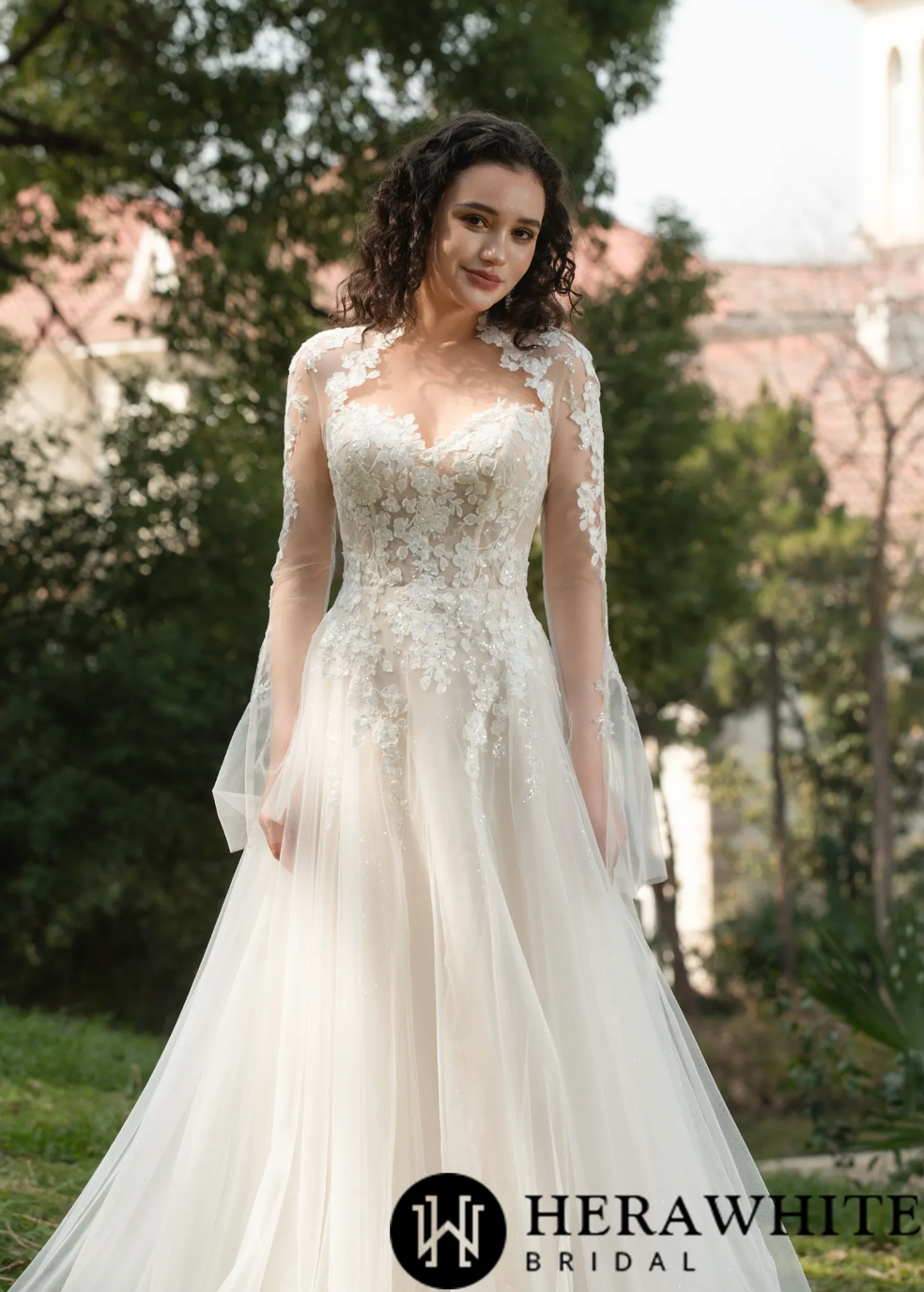 Blossom Lace Long-Sleeve Wedding Dress featuring floral lace appliqués and tulle skirt, ideal for modern brides.