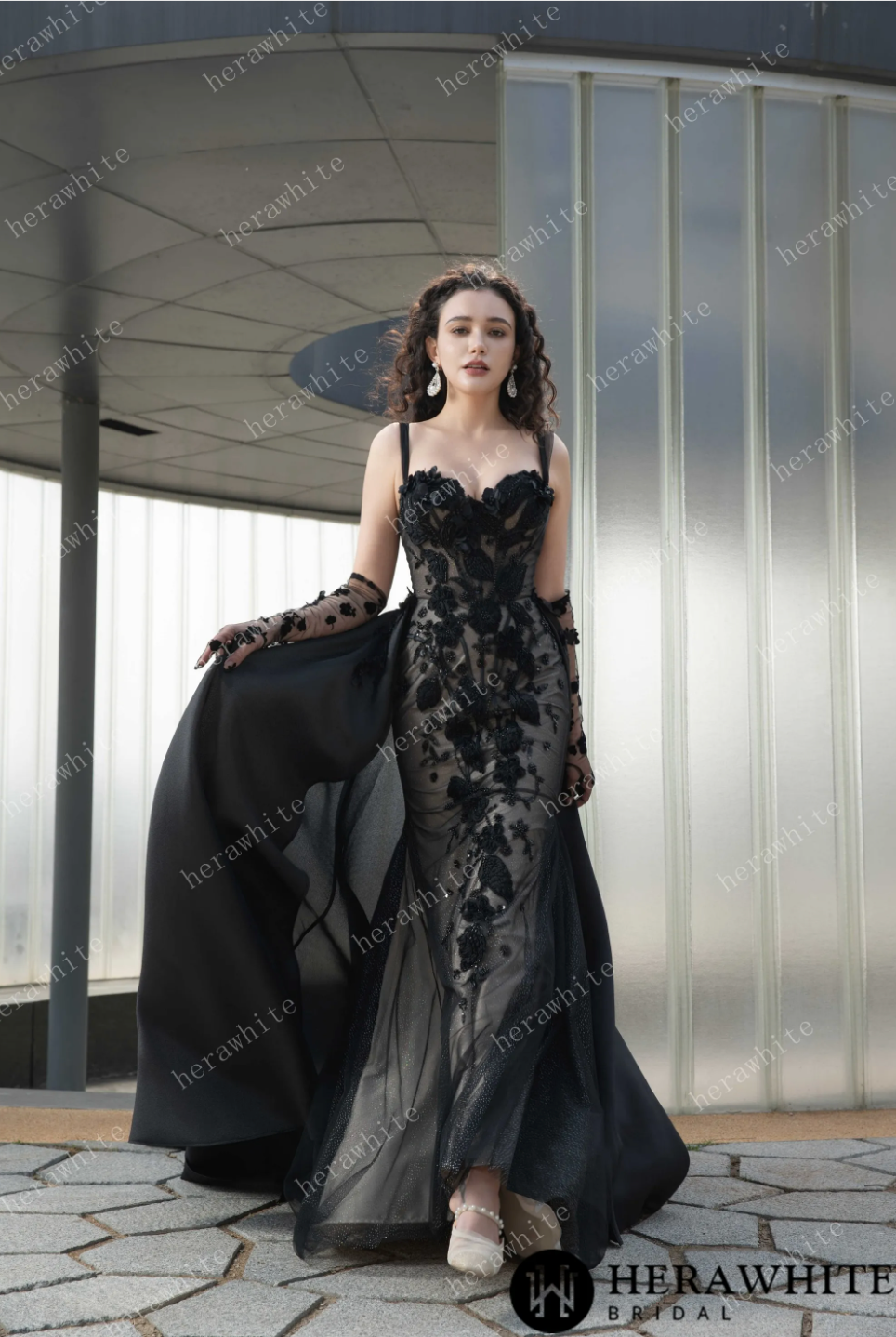 Elegant black wedding dress with sweetheart neckline, intricate lace appliqués, and matching gloves for a unique bridal look.