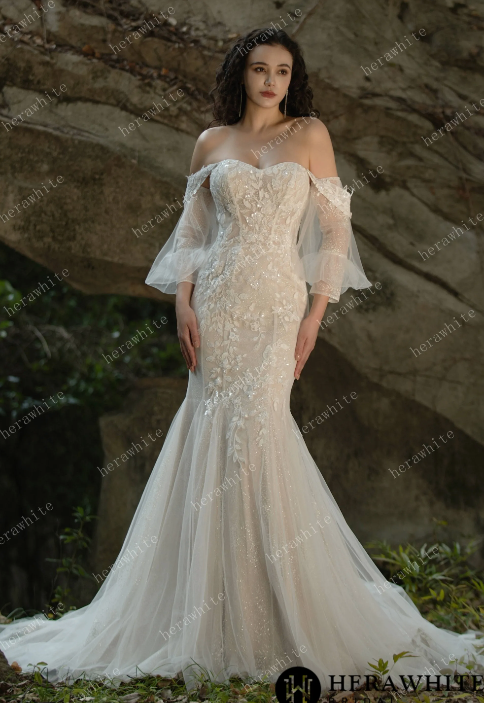 Stunning off-the-shoulder sequined lace wedding dress with a fit and flare silhouette and dramatic train.