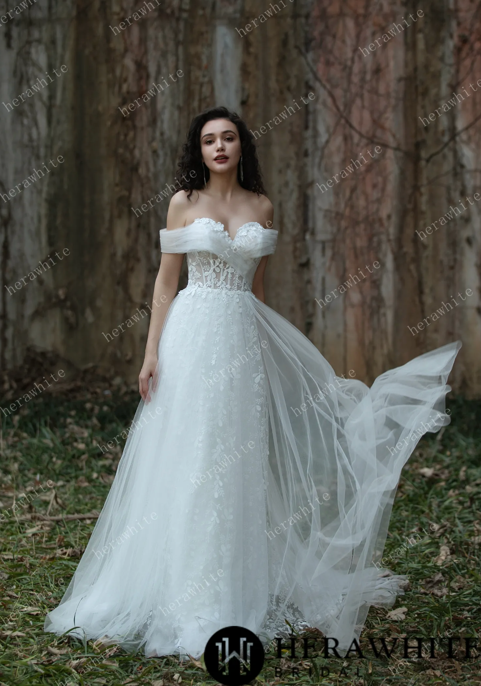Sweetheart A-line lace bridal gown with off-shoulder design and tulle fabric, set against a natural background.