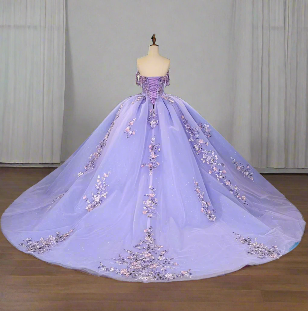 Elegant purple lilac floral quinceanera dress with a voluminous skirt and corset bodice, featuring detailed floral embellishments.