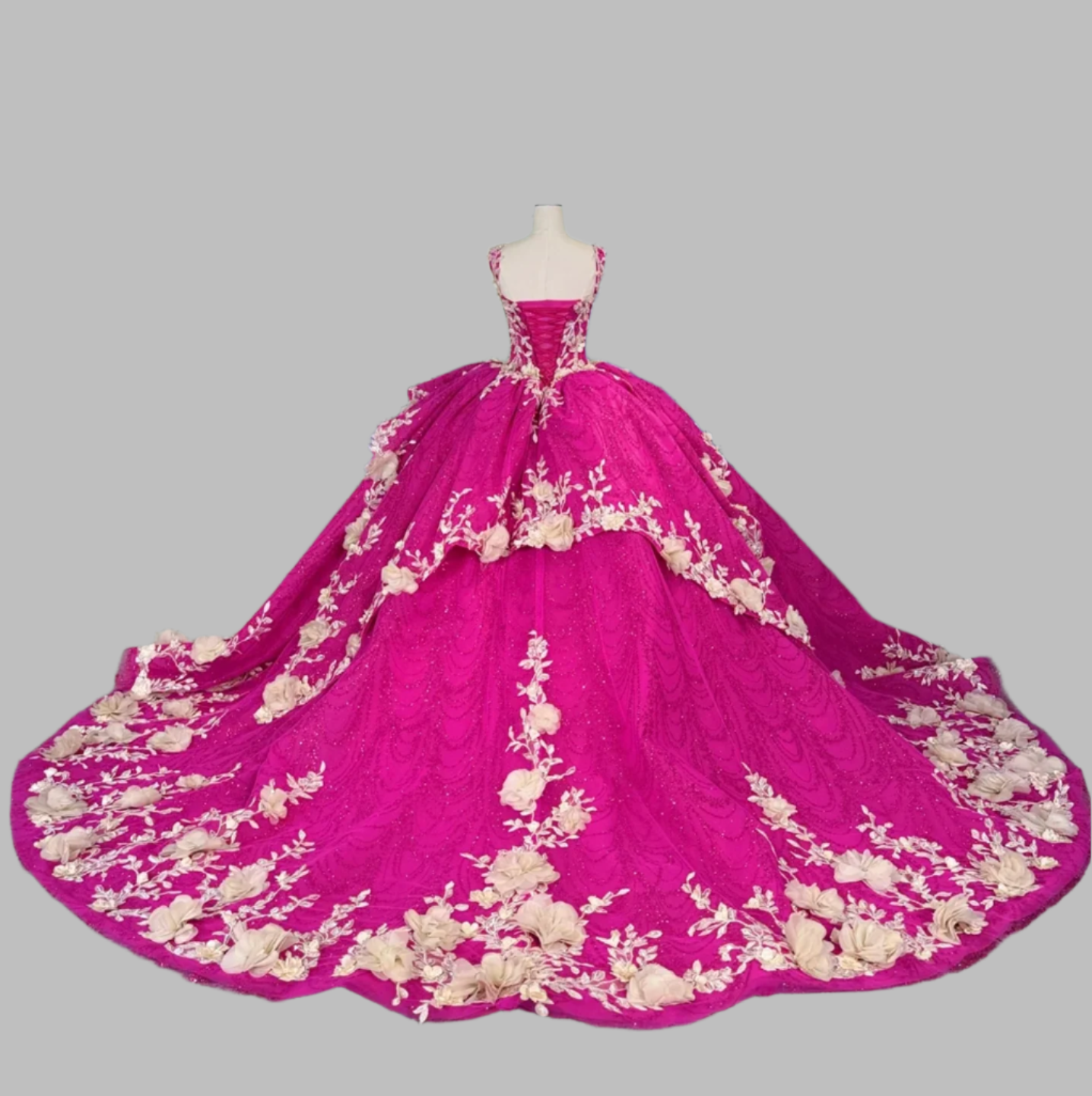 Pink gown with floral embroidery on a mannequin