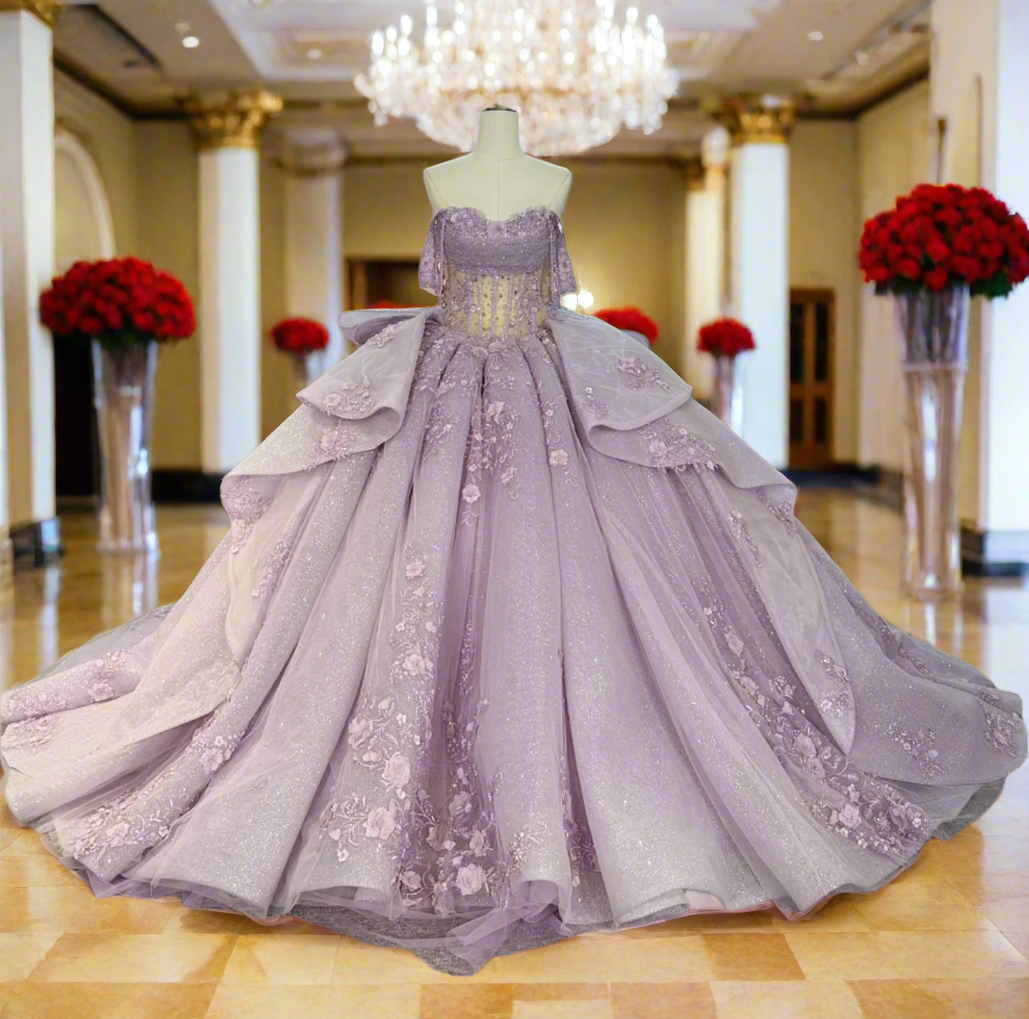 Lilac purple Quinceañera dress off shoulder with floral detailing and voluminous skirt, perfect for a special occasion.