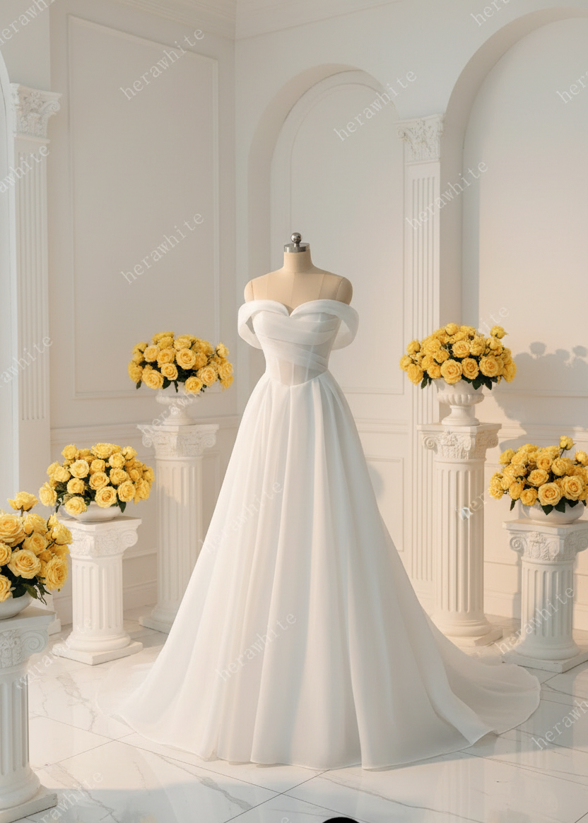 Organza satin A-line wedding dress with removable off-the-shoulder straps and sweetheart neckline on display.