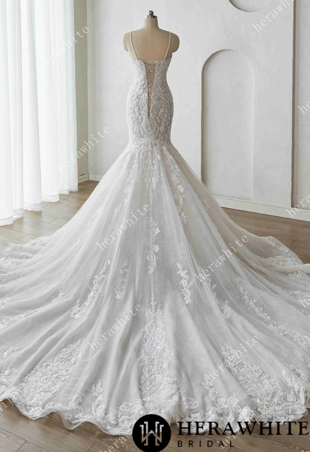 Elegant lace wedding dress on a mannequin against a white background with 'Herawhite Bridal' branding.