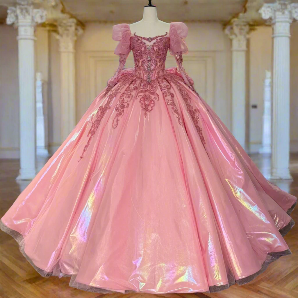 Pink evening gown on a mannequin with other dresses in the background