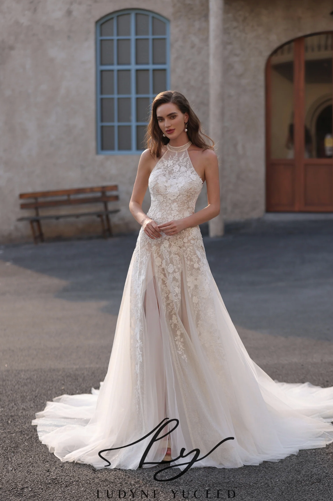 Wedding Dress Floral Lace Halter Neck A Line Bridal Gown, this wedding dress showcases a high neck halter design, exuding elegance and grace. The bodice, crafted from intricate floral lace, hugs the figure beautifully, while the sheer tulle skirt features a daring side slit for a touch o