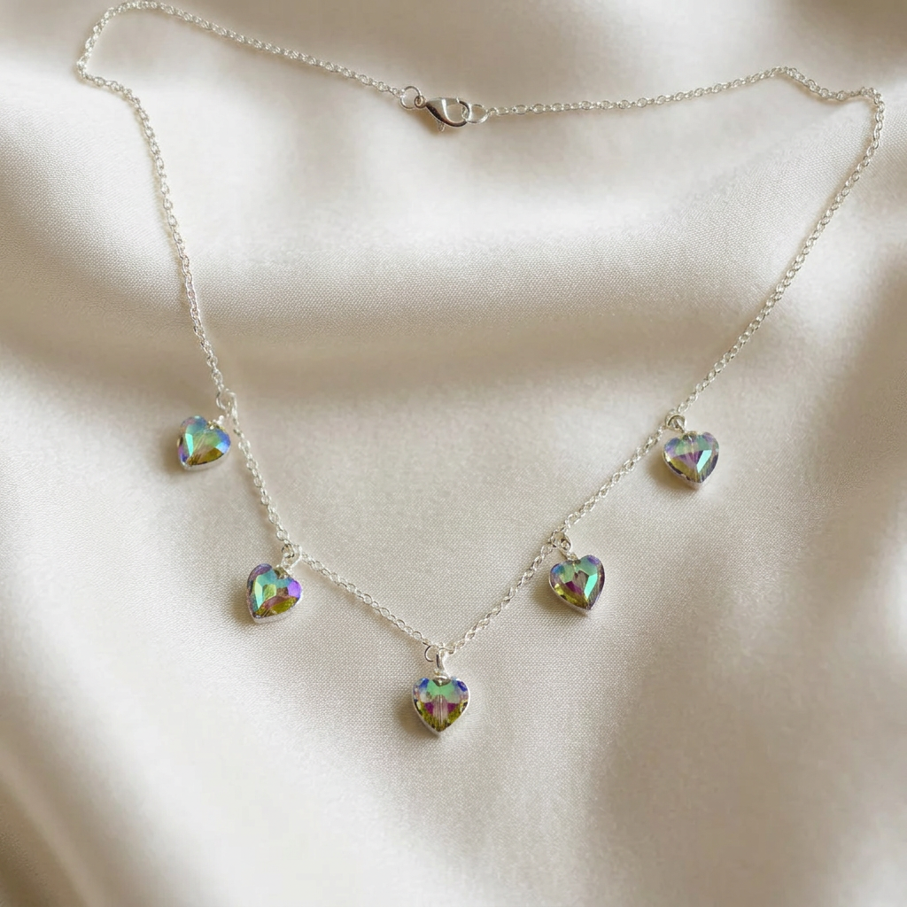 Iridescent crystal heart necklace with five rainbow-sparkle heart charms