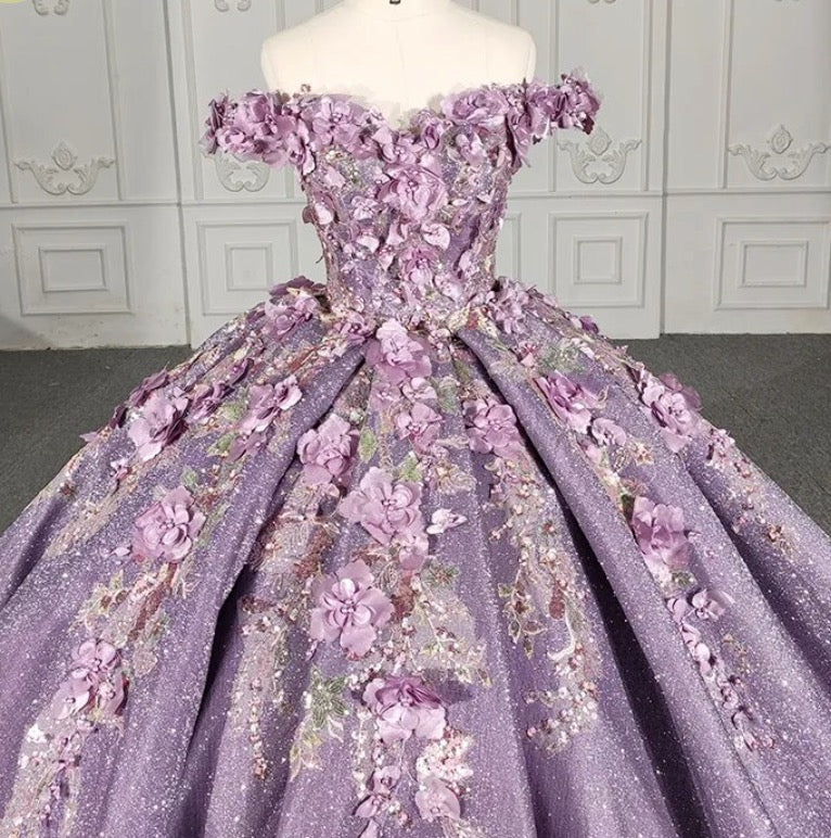 Purple floral A-line sequined ball gown with off-the-shoulder sleeves and intricate flower embellishments.