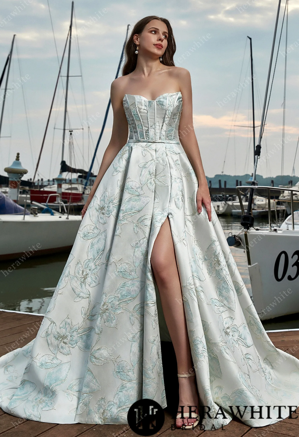 Elegant satin sleeveless A-line wedding dress with thigh-high slit and floral design, perfect for a fashion-forward bride.