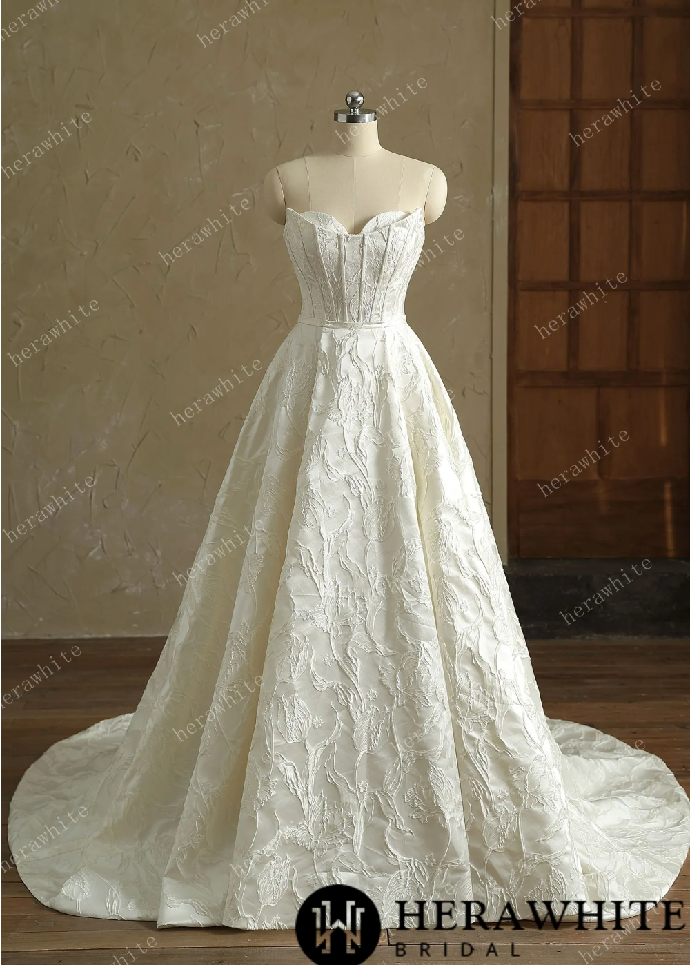Elegant ivory A-line wedding dress with strapless sweetheart neckline and flowing skirt.