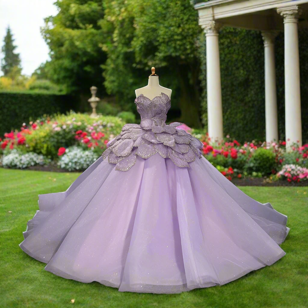Elegant purple lilac quinceañera dress with lace-up back, sleeveless design, and layered sparkling skirt.