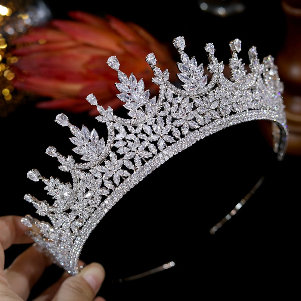 Tiara Crown Cubic Zirconia Crystal Wedding Accessory, dazzles with its finely-cut, faceted zirconia and bottom rim lined with alternating scalloped, high-pointed crystals in a tri-colored leaf design. Material: Cubic zirconia 