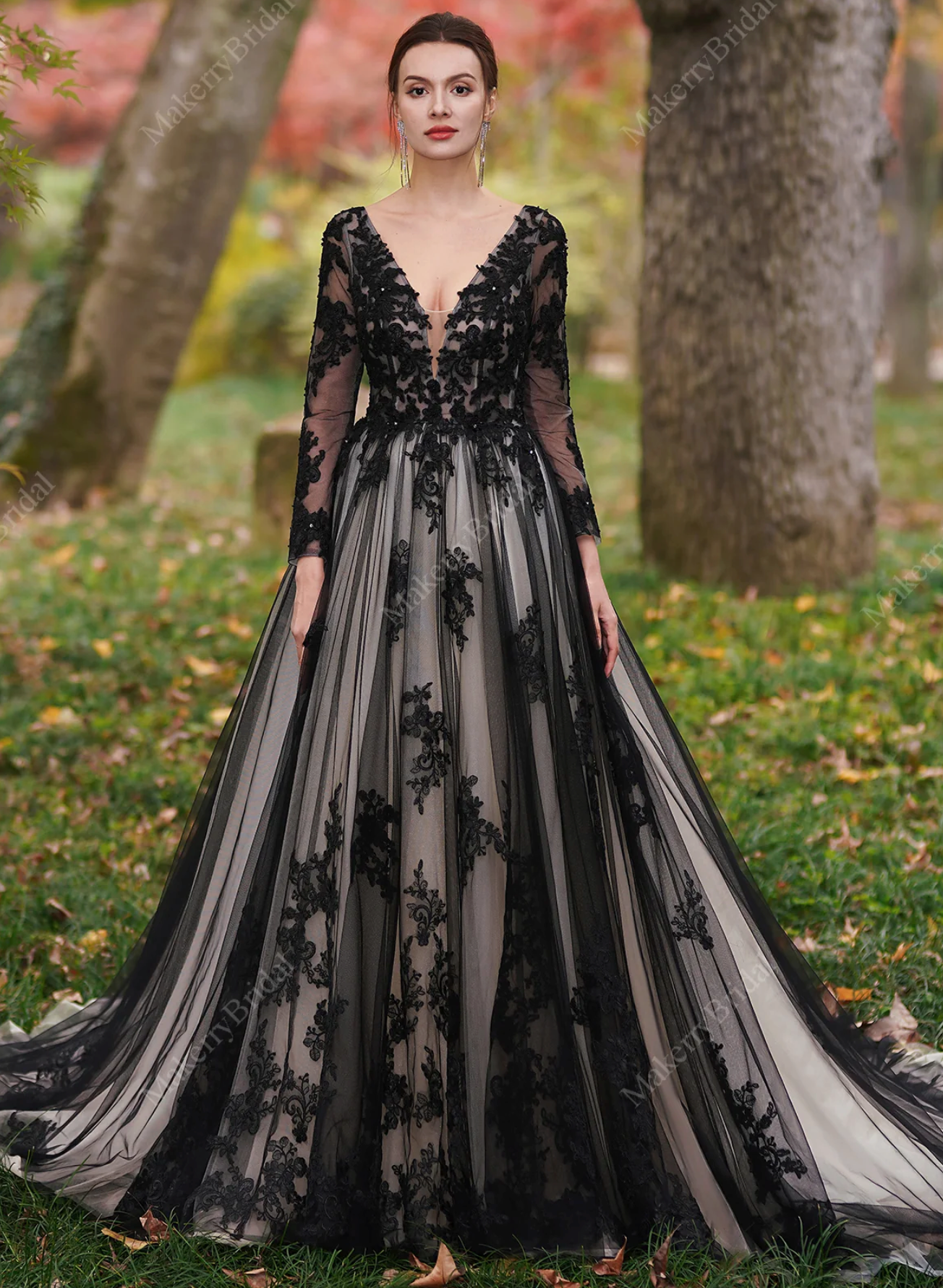 Black over nude wedding dress with beaded lace, sheer bodice, and illusion sleeves, perfect for unconventional brides.