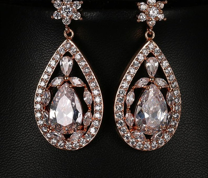 Large water drop Crystal Party Earrings Evening Event Jewelry Accessory with water drop pattern come in rose gold and platinum both with clear stones.